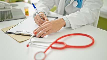 Young caucasian man doctor writing medical report having consultation at clinicc