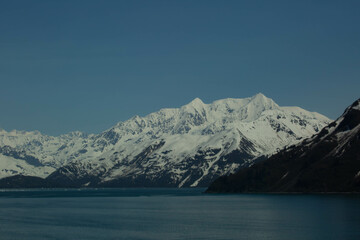 scenic Alaskan snowcapped mountains from an ocean view heading into Juneau Alaska