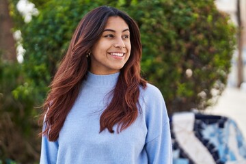 Fototapeta premium Young hispanic woman smiling confident standing at park