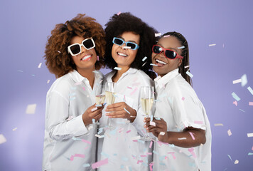 Joyful Black Women In Sunglasses Clinking Glasses On Purple Background