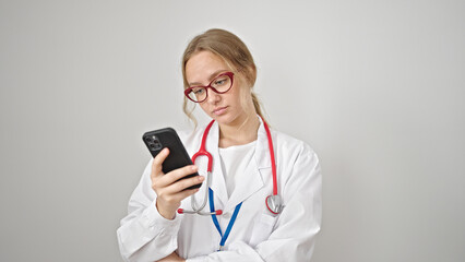 Young blonde woman doctor using smartphone over isolated white background