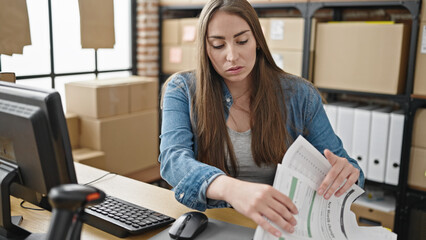 Young beautiful hispanic woman ecommerce business worker stressed looking for document at office