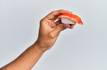  Hand of man holding prawn nigiri over isolated white background