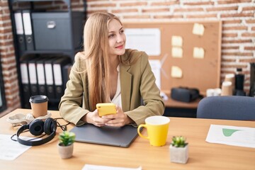 Young caucasian woman business worker using smartphone working at office