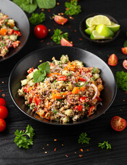 Red and white quinoa tabbouleh salad with tomatoes, paprika and mint. Vegetarian, vegan food concept