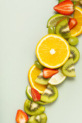 Citrus fruits and strawberries flat lay, top view. Summer layout on colored background