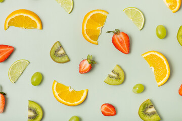 Citrus fruits and strawberries, pattern flat lay, top view. Summer layout on colored background