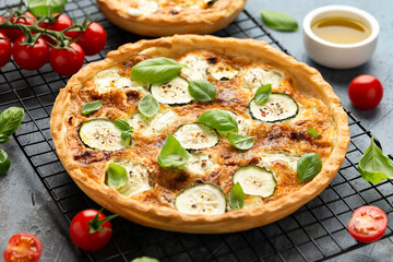 Sun baked tomato, goats cheese and courgette quiche served in cast iron pan with side salad