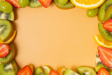 Frame made from citrus fruits and strawberries, composition with copy space flat lay, top view