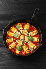Baked zucchini rolls with ricotta, pecorino cheese in marinara sauce. Healthy food