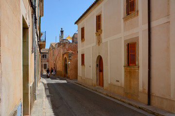 Beautiful old streets with houses and brick walls of a small medieval town, Italy