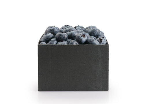 Fresh premium blueberries in black paper box isolated on white background