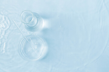 laboratory utensils in water. top view. Petri dishes, flasks, test tubes.  Blue hue.