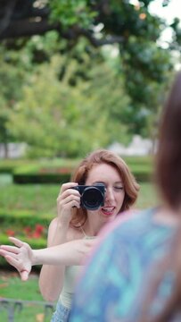 Woman with a camera organising a group of friends to take a pic