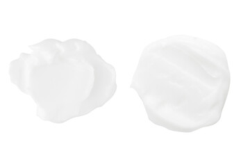 A set of different strokes of white cream on a white background.