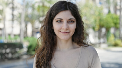 Young beautiful hispanic woman smiling confident standing at park