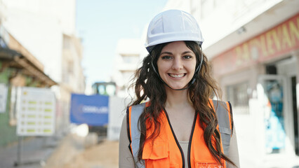 Young beautiful hispanic woman builder smiling confident standing at street