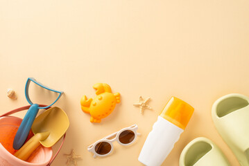Relaxing beach getaway with your infant: top-down view of toys, sandcastle tools, sunscreen bottle, glasses, rubber slippers, shell, starfish on calming beige background, offering space for text or ad