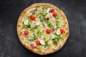 Appetizing Pizza Caesar, with meat, eggs, tomatoes and herbs