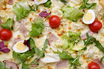 Appetizing Pizza Caesar, with meat, eggs, tomatoes and herbs