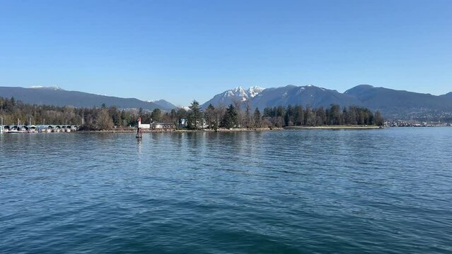 Vancouver, Canada - march 11, 2023: HMCS Discovery military base on a Deadman Island in Vancouver Stanley Park with mountains in the background