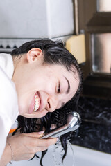 woman washing her head with the shower. daily routine body care and beauty