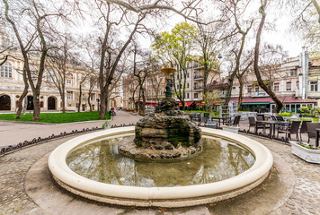 Obraz premium Alpine slide in the middle of a small fountain inside the city park