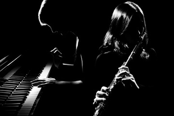 Musical duet piano and flute player. Pianist and flutist classical musicians - 614549571
