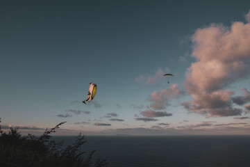 Fototapeta na wymiar Paragliders in the Sunset