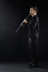 Naklejka premium Clarinet player classical musician. Man playing clarinette