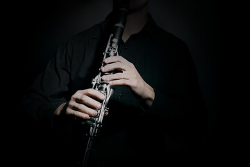 Clarinet player. Clarinetist hands playing woodwind instrument close up