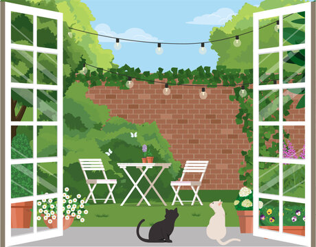Cozy English patio with garden furniture against the backdrop of climbing ivy on a brick wall.