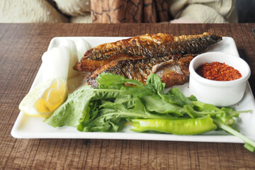 Fish fillet , chips and salad on a plate 