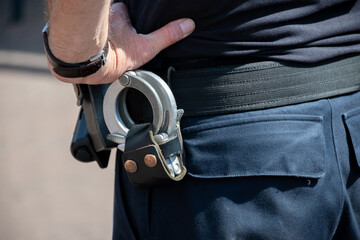 Police officer, policeman with handcluffs on belt, clime prevention, close up