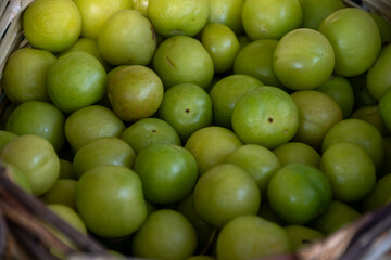 Green turkish plum can erik in basket