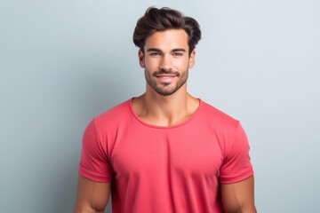 Obraz premium Portrait of a muscular handsome guy wearing a plain red t-shirt, isolated on a pastel background. Generative AI illustration.