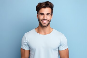 Fototapeta premium Portrait of a muscular handsome guy wearing a plain t-shirt, isolated on a pastel background. Generative AI illustration.