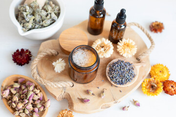 Botanical blends, herbs, essencial oils for naturopathy. Natural remedy, herbal medicine, blends for bath and tea on wooden table background