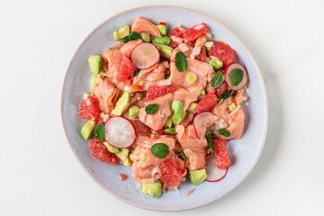 Fresh homemade Chilean salmon ceviche with grapefruit, avocado, radish, onion and mint. Healthy diet food