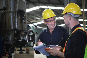 Fototapeta premium Supervisorand Young Engineer Working with big machine.