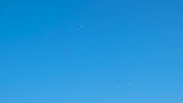 Extreme skydiving into fresh air. A skydiving team have an extreme fly against clear blue sky in summer.