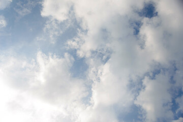 Scattered cloud clusters in a blue sky, blue sky background with white clouds.