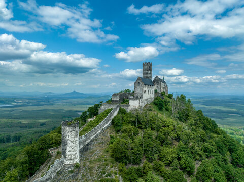 Aerial view of Bezdez castle with ruined palace and church building towering over the surrounding countryside