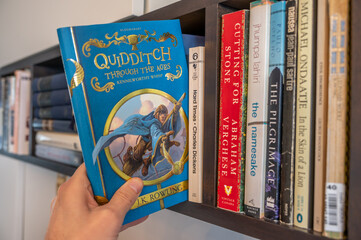 Naklejka premium Calgary, Alberta - June 17, 2023: Cover of J.K. Rowlings Quidditch Throught the Ages.