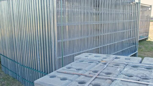 Stacked Sections of Metal Mesh Wire Fence Ready for Building Temporary Security Perimeter Fencing around Public Event Outdoor Open Air Music Festival