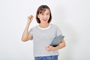 Portrait of a smiling beautiful Asian woman freelancer using a digital tablet and looking pleased with the device screen, shopping online, on white background
