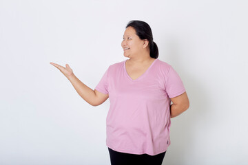Beautiful Asian plus-size woman smiles with positive emotion, feeling happy and proud of her body overweight. Portrait shot on white background with copy space.