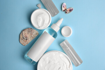 Flat lay composition with different cosmetic products on light blue background