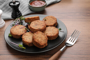 Delicious vegan cutlets served on wooden table