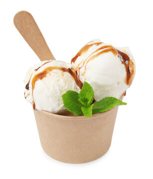 Scoops of delicious ice cream with caramel sauce and mint in paper cup isolated on white